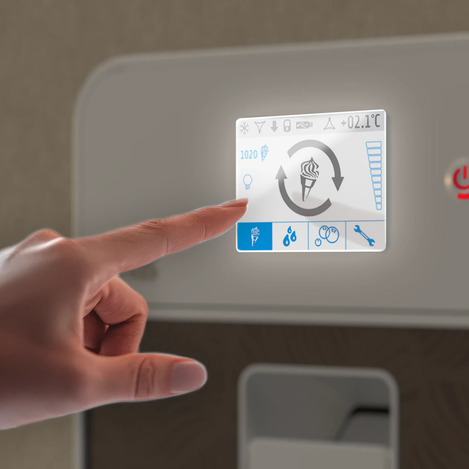 A finger touches the „Bras“ Is-Cream touch screen showing an ice cream icon and the temperature